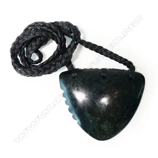 TE KAHA carved (dark arahura) pounamu lge notched triangular form pendant with certificate 2016. W.63mm.