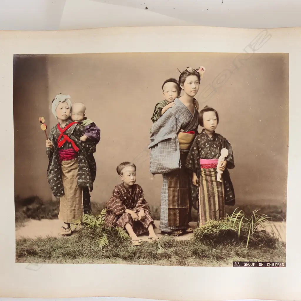 A late 19thC Japanese large photo album the black lacquered cover with a coastal scene including rickshaw insects and florals Image 1++