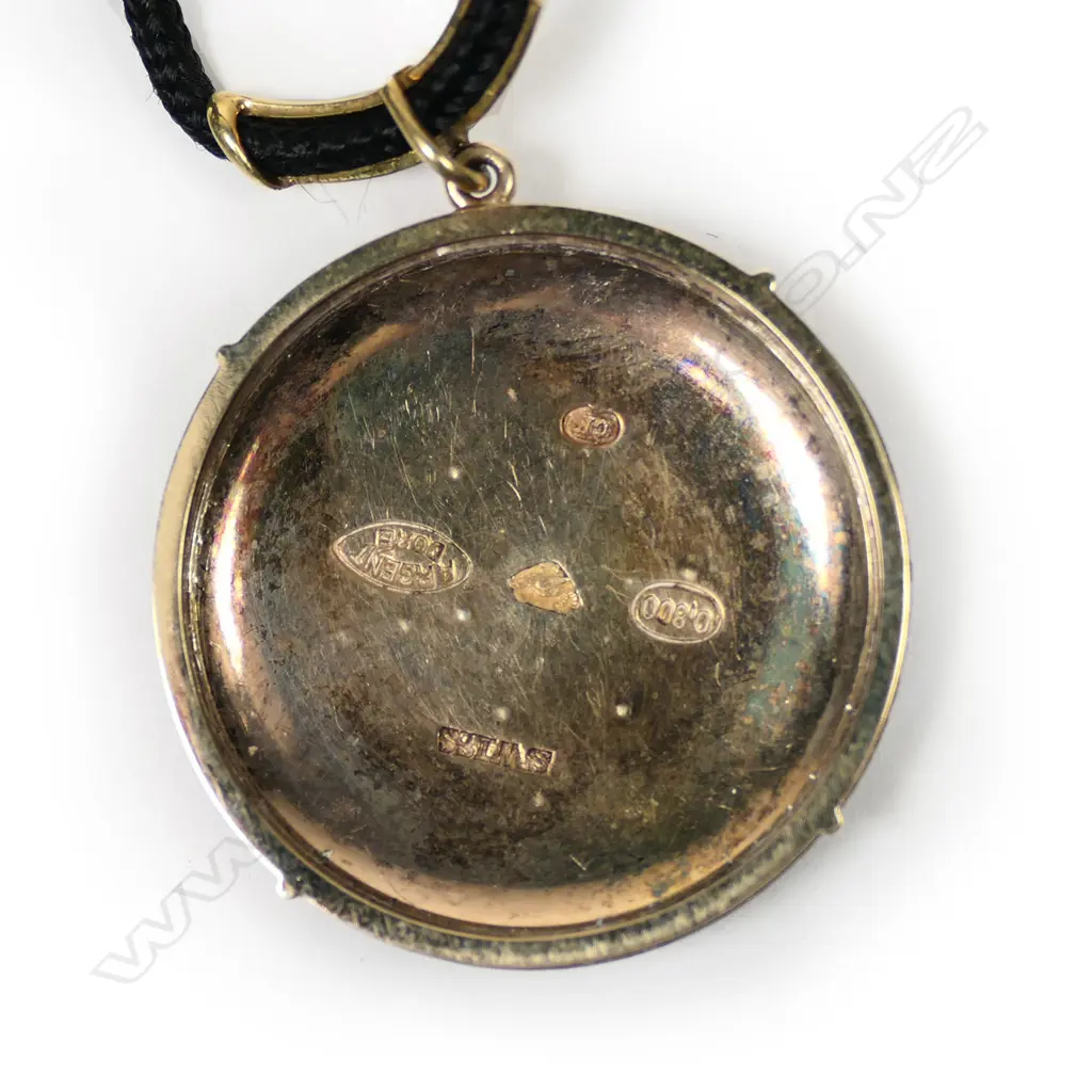A 9ct gold and silver watch back pendant, Image 1++