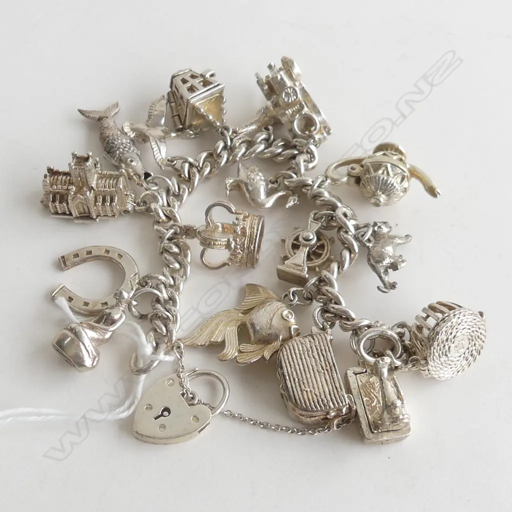 STG BRACELET w. 17 ASST. CHARMS 82 GRAMS Image 1++