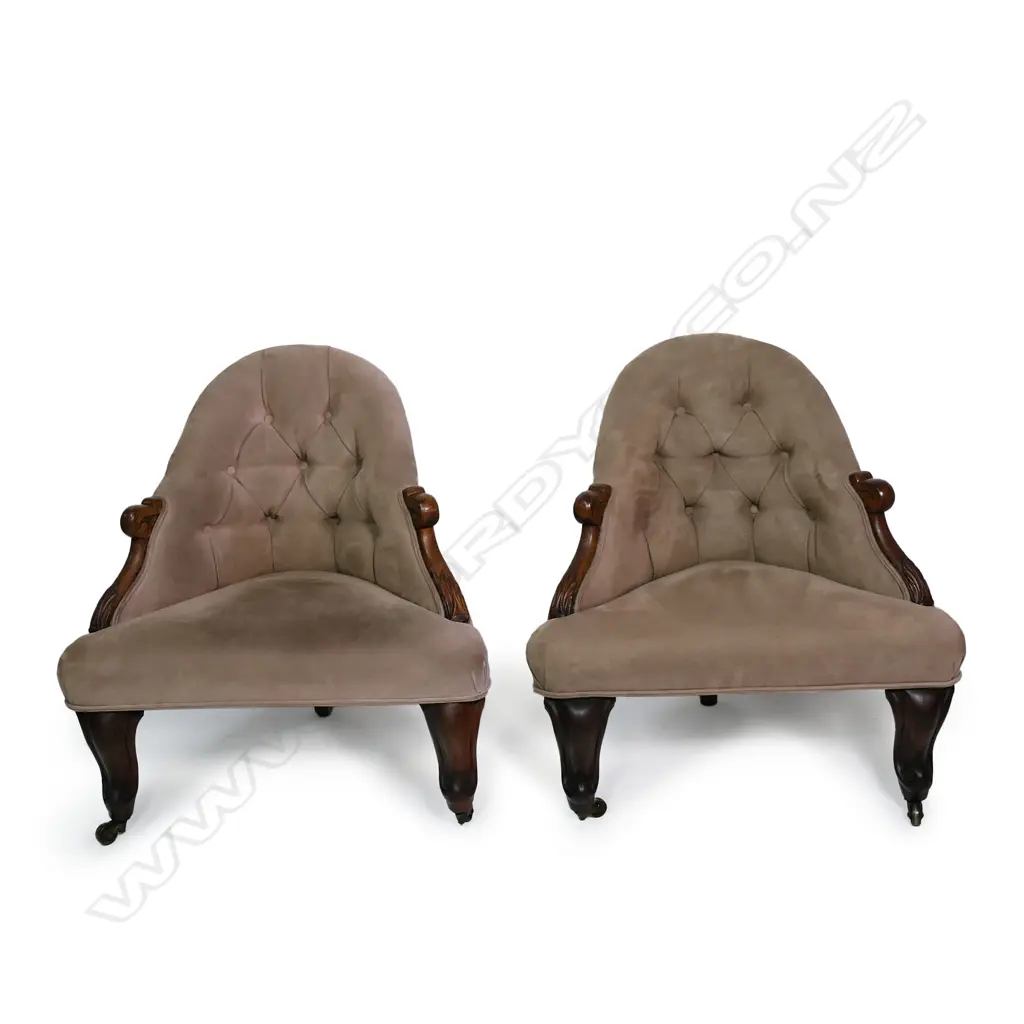 A pair of uncommon Victorian rosewood detailed corner chairs / the arched buttoned backs and sprung seats upholstered in tan suede / the carved rosewood scroll arms and feet with acanthus leaf detail. Original brass castors. 720 X 760mm. Image 1++