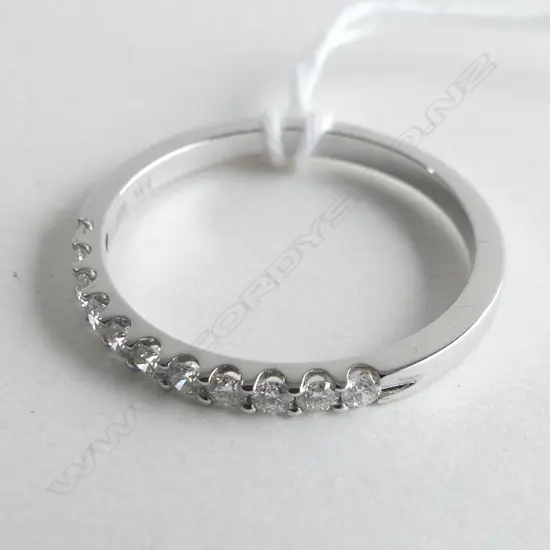 9CT WHITE GOLD 33CT CLAW SET BAND 2.4GMS (WITH VALUATION)