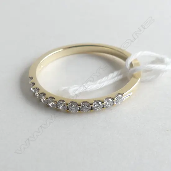 9CT YELLOW GOLD .33CT CLAW SET BAND 2.0 GMS (WITH VALUATION)