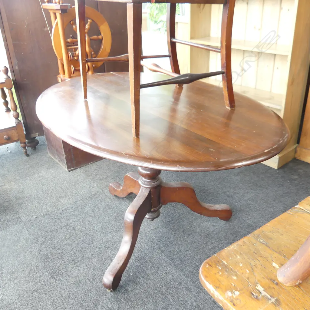 C 1900 RIMU OVAL SHAPED TILT TABLE. TURNED CENTRAL SUPPORT ON THREE SPLAY LEGS. SPLIT TO TOP NEEDS ATTENTION. H.730mm Image 1++
