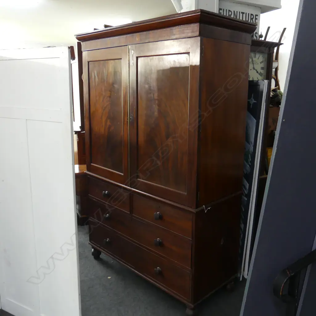 GEORGE III MAHOGANY LINEN PRESS. FLAME PANELLED TOP WITH 5  SLIDING SHELVES. 4 DRAWER BASE ON TURNED FEET. H.2050 W1380 Image 1++
