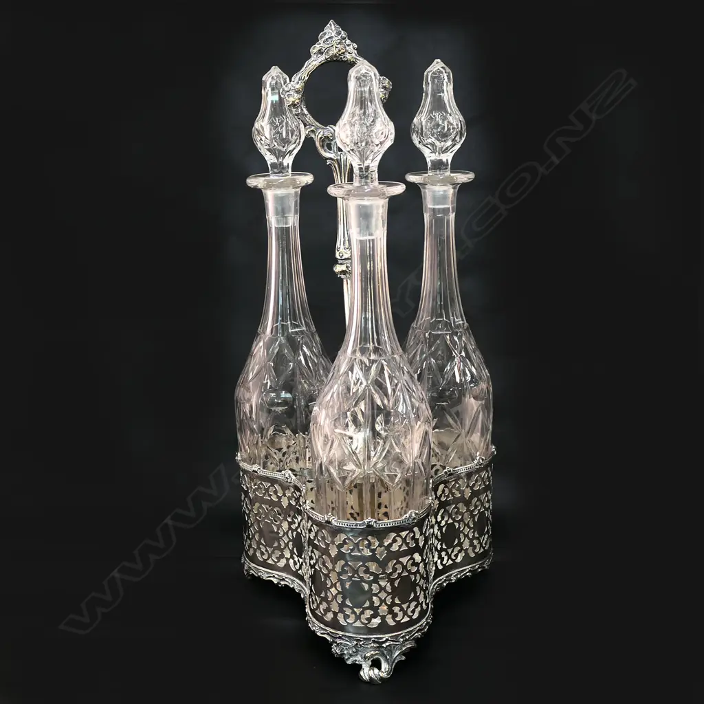 A Victorian silver plate triple decanter tantalus stand, Image 1++
