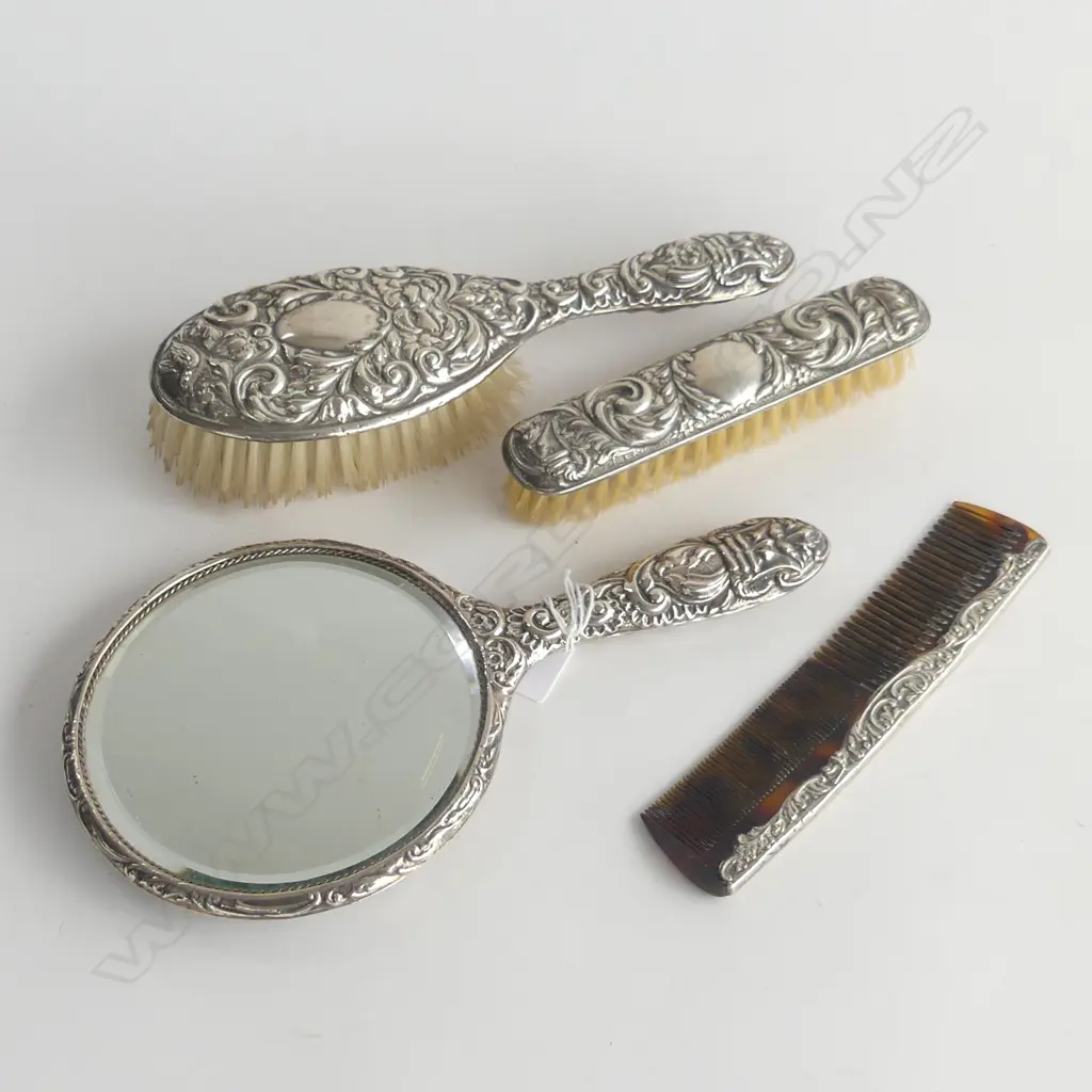 4 PCE SILVER BACKED VANITY SET: hand mirror + 2 brushes + comb . Embossed w masks etc  Image 1++