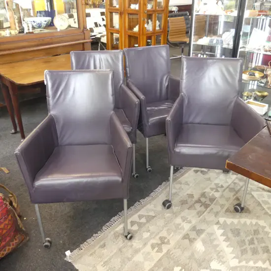4 VINYL DINING CHAIRS ON CASTORS 