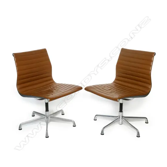 A pair of tan Eames EA330-266 office conference chairs,