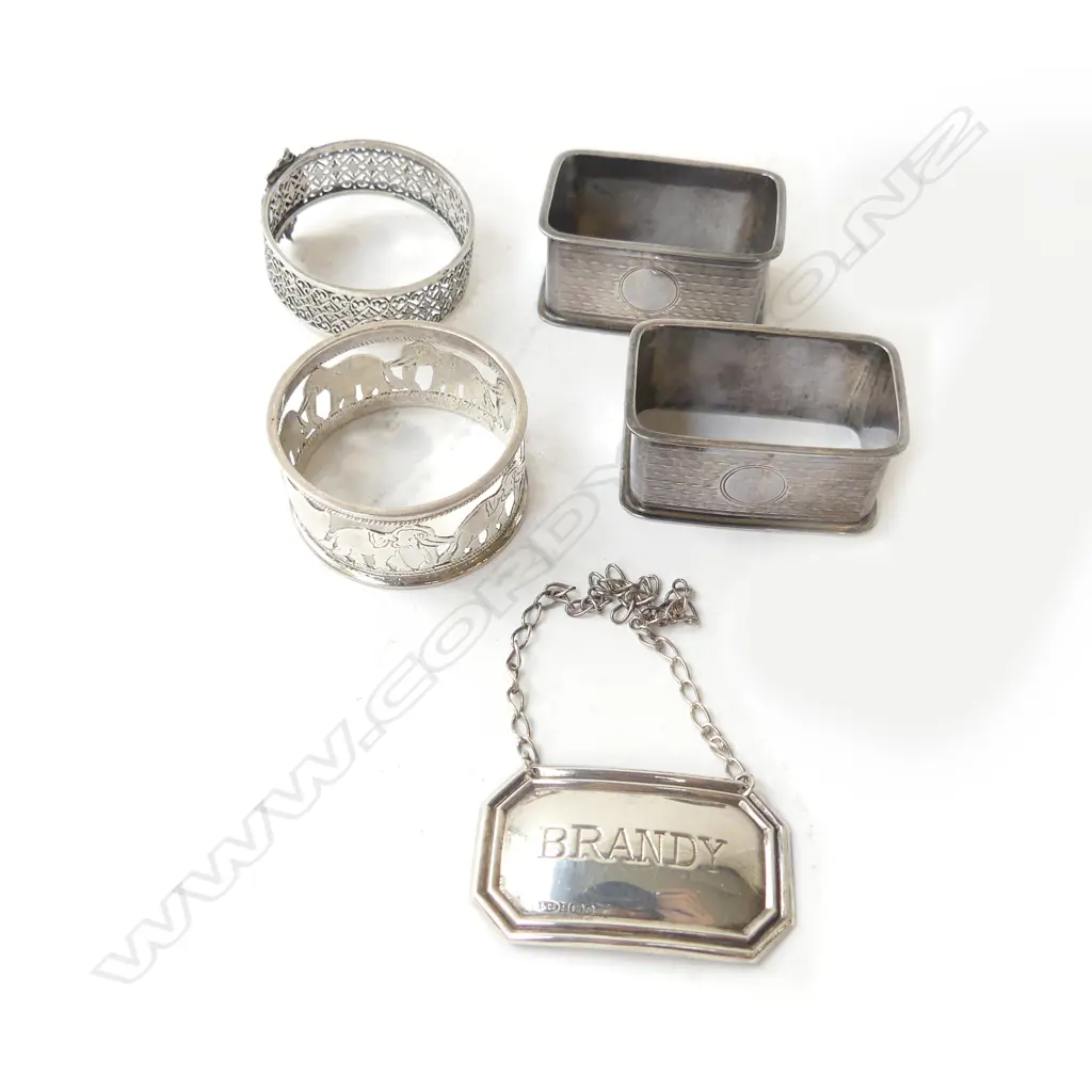 3 STG SILVER NAPKIN RINGS (+1 EP) + STG BRANDY DECANTER LABEL, B'HAM 1940 67gms Image 1++