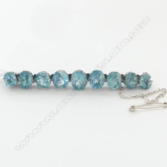 VINTAGE SILVER AND BLUE ZIRCON BAR BROOCH (9 graduated facet cut zircon)
