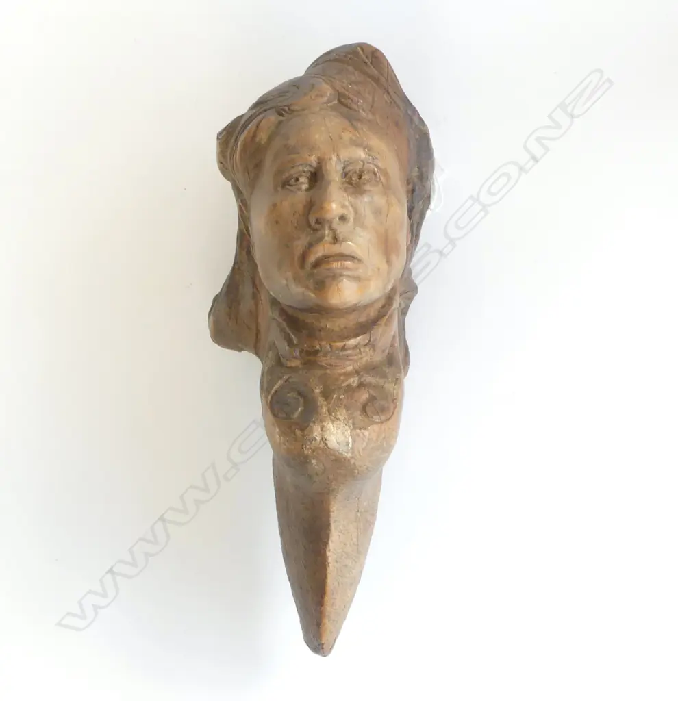 An old tree trunk section carved with the bust of a woman Image 1++