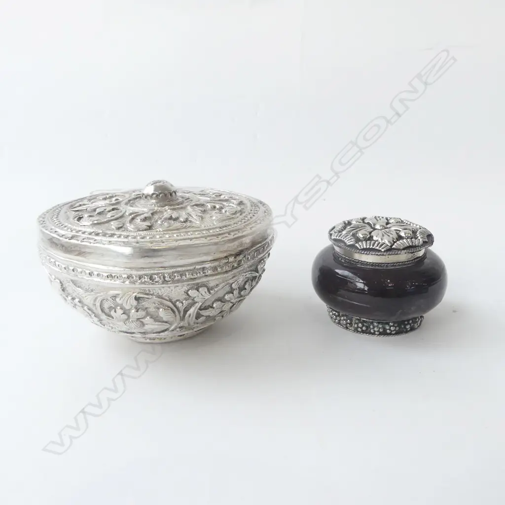 TWO EASTERN SILVER LIDDED TRINKET BOWLS, ONE HEAVILY EMBOSSED, ONE WITH PURPLE GLASS, D.90MM & D.50MM Image 1++