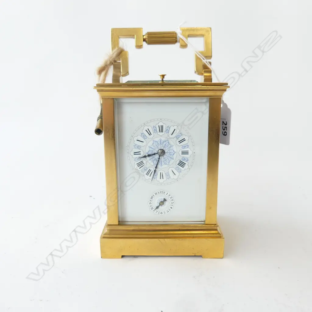 A quality 19thC French gilt brass repeater carriage clock the white enamel dial with Roman numerals, the subsidiary dial with Arabic numerals, blue highlights. The quality movement striking on a gong. Hour and half hour striking. Running, with key. H.180mm (to handle top). Image 1++