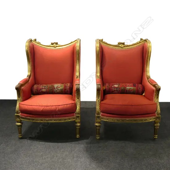 A pair of French style wing back armchairs,