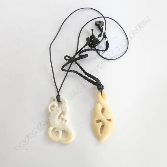 2 CARVED BONE PENDANT NECKLACES; TANIWHA & OTHER H.65mm