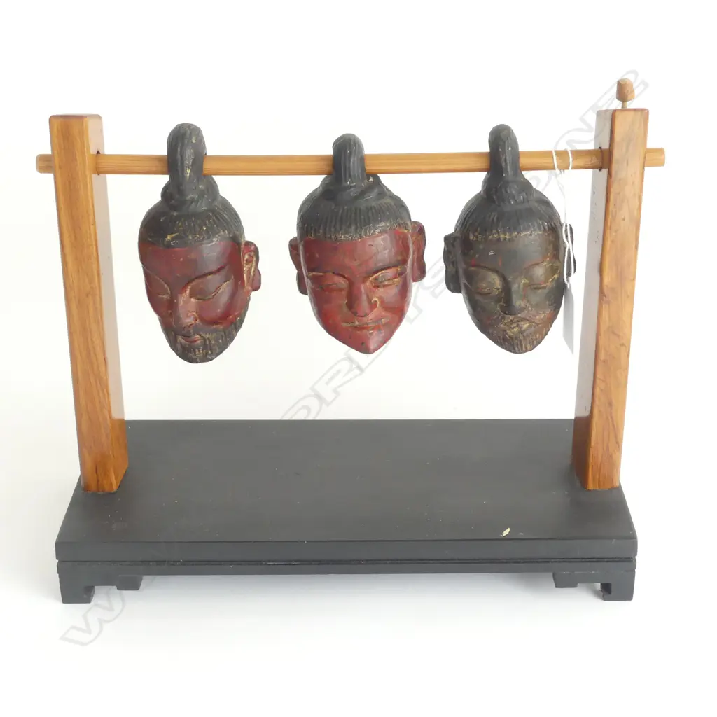 (T83) A Meiji period Japanese table sculpture c.1880 depicting three carved wooden and painted lacquered severed heads, from the excavation killing field (on stand). Image 1++