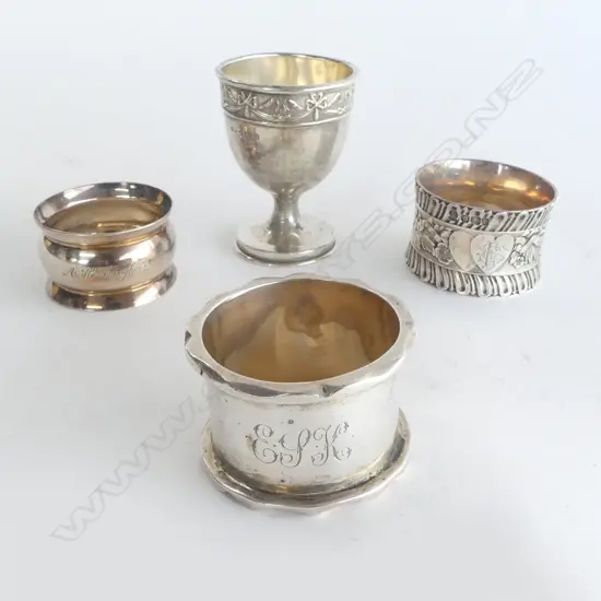 3 SILVER NAPKIN RINGS & SILVER EGG CUP. 146gms. 1 napkin ring of heavy cast quality