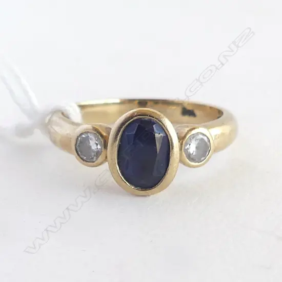 9CT Y/G BLUE  SYN SAPPHIRE & CZ RING WITH RUB OVER SETTING  3.4gms SIZE O