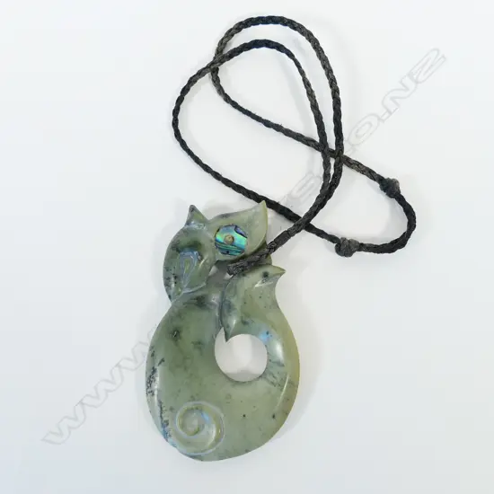 A contemporary large Māori Manaia carved pounamu pendant
