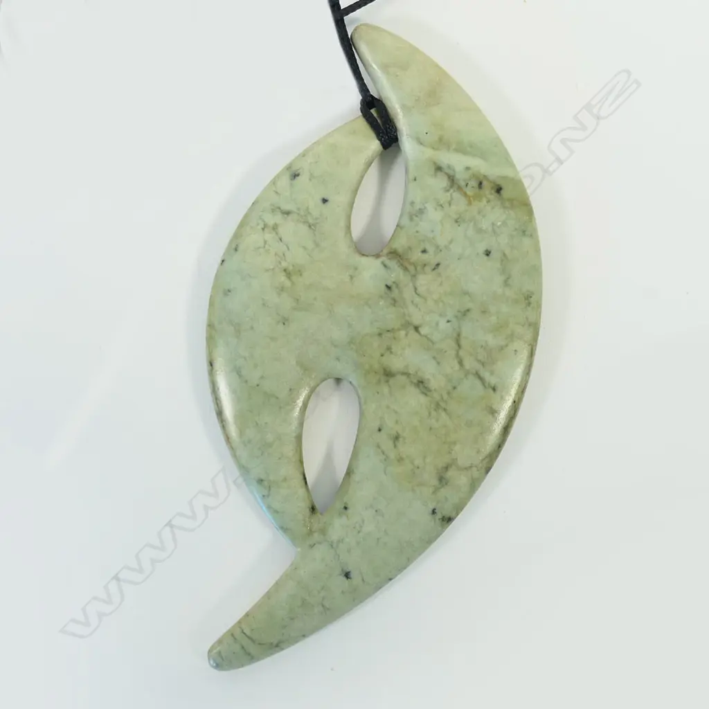 A contemporary Māori large stylised carved pounamu pendant Image 1++