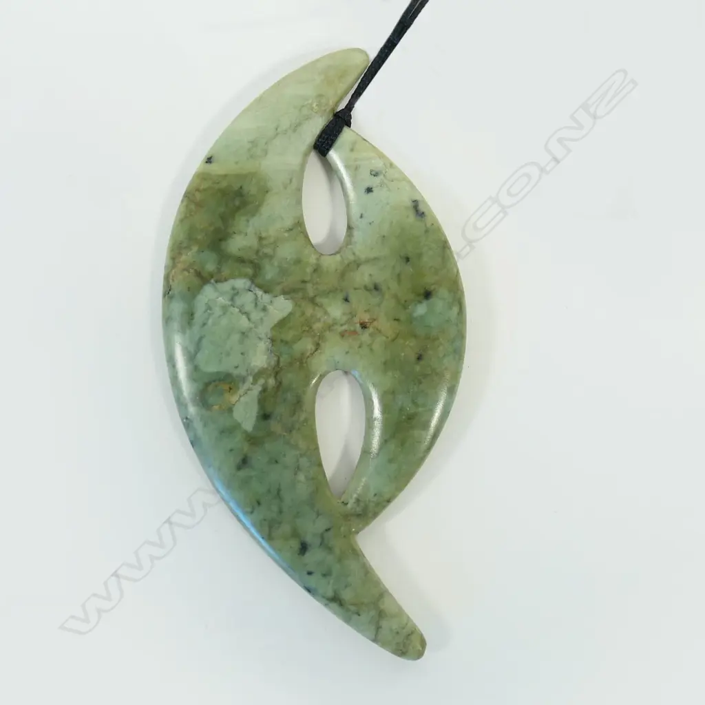 A contemporary Māori large stylised carved pounamu pendant Image 1++
