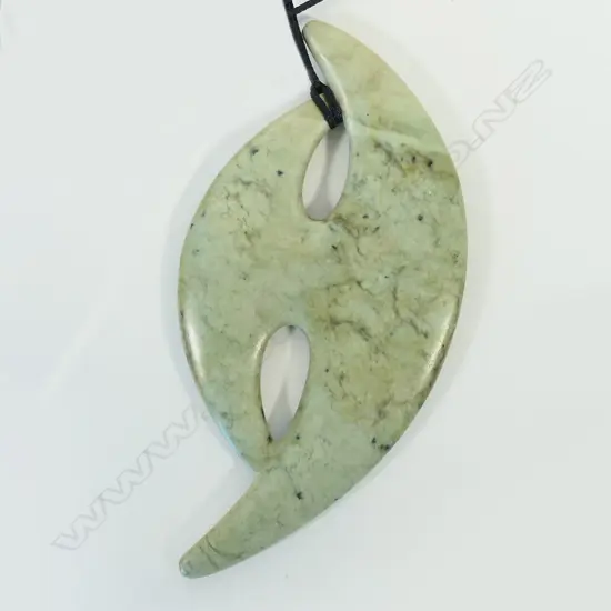 A contemporary Māori large stylised carved pounamu pendant