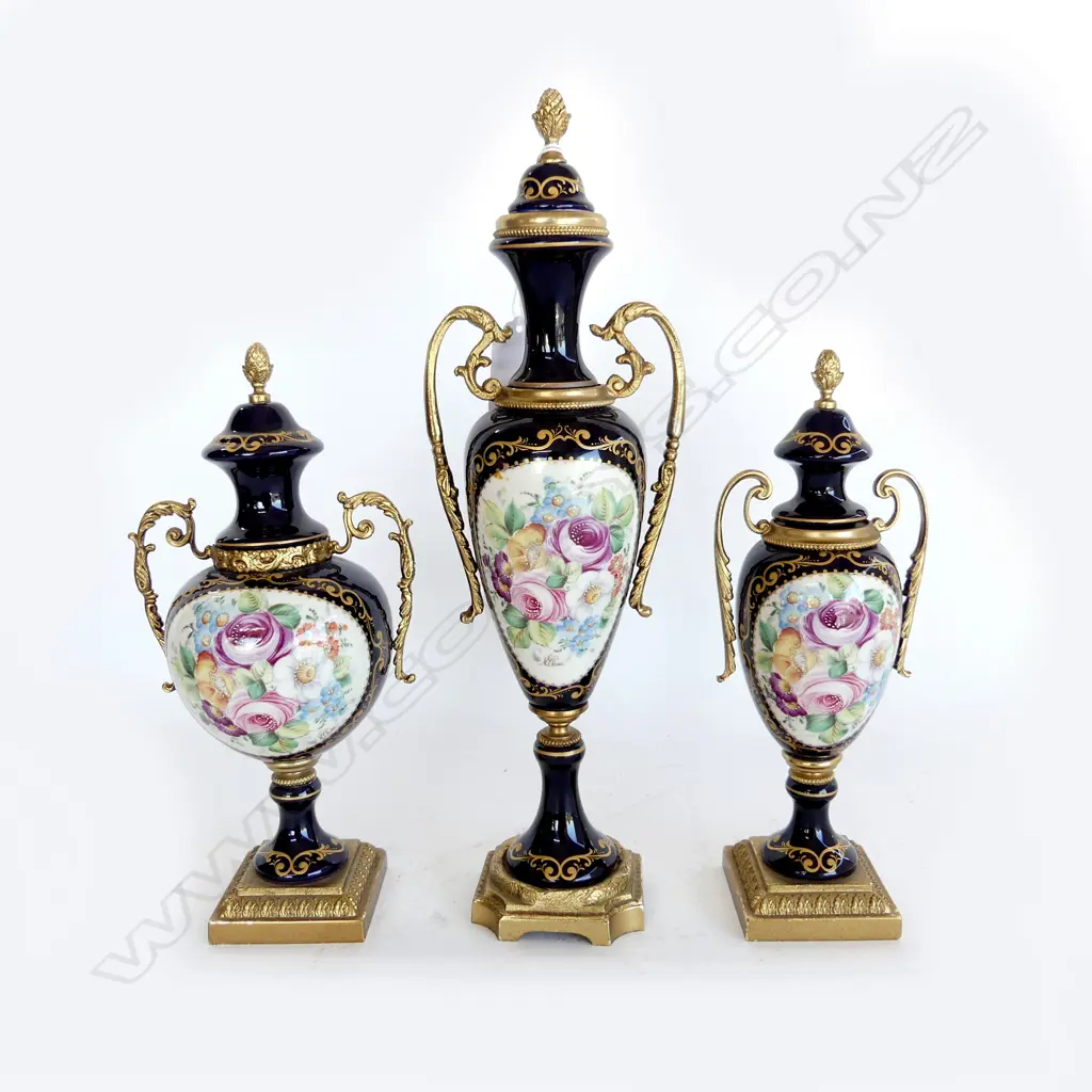 3 SEVRES PORCELAIN & ORMOLU URNS floral panels on cobalt ground signed. Tallest 310mm. Image 1++