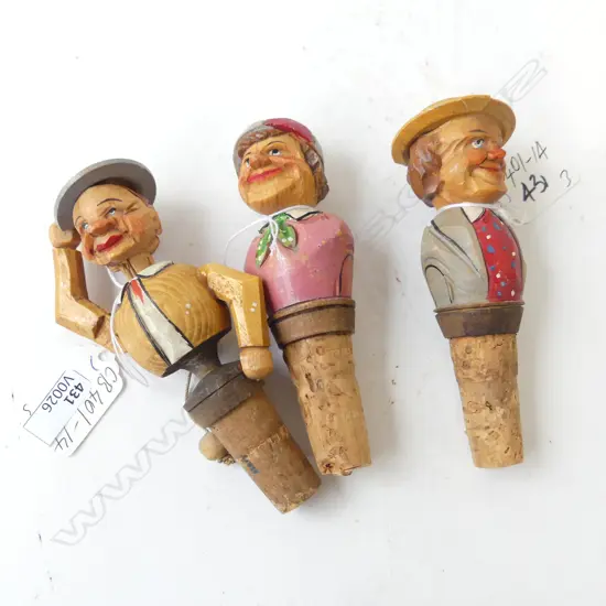 THREE CARVED GERMAN BLACK FOREST BOTTLE STOPS, ONE ARTICULATED MAN DOFFING HAT , A JOCKEY & GENTLEMEN WITH HAT (CHIP) 