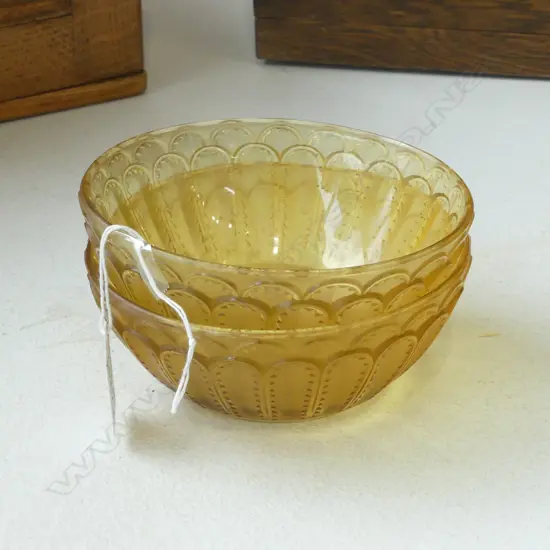 A pair of René Lalique (1860-1945) small amber glass bowls Jaffa No.5, No.3255, acid-etched 'R Lalique France'. Moulded with overlapping stylised serrated leaves. Dia.133mm. One with small chip.