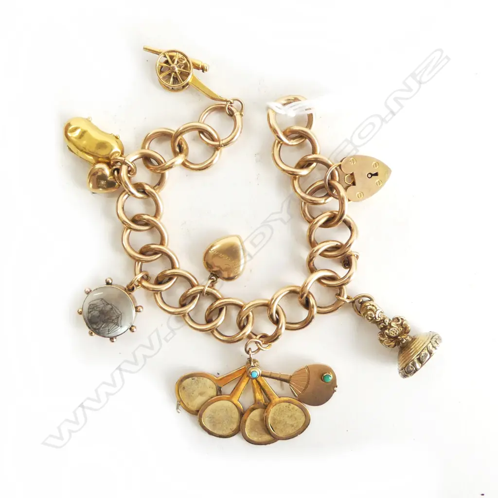 15CT GOLD CHARM BRACELET  41.2 grams including charms. Bracelet is 15ct. Clasp is 9ct. Most charms 9ct. The seal is... Image 1++