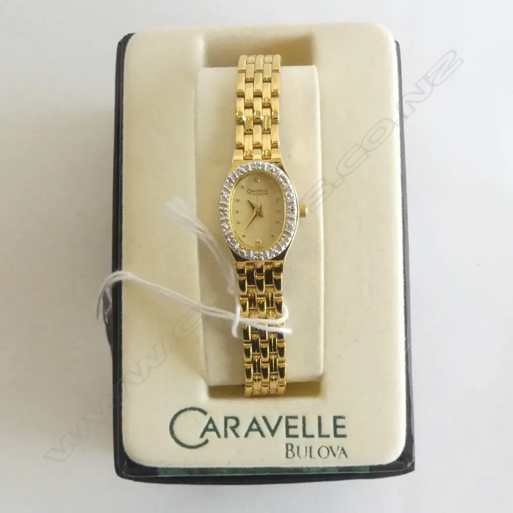 LADIES GOLD PLATE BULOVA WRIST WATCH WITH BOX AND PAPERS TINY DIAMONDS AROUND DIAL. Image 1++