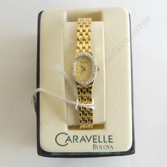 LADIES GOLD PLATE BULOVA WRIST WATCH WITH BOX AND PAPERS TINY DIAMONDS AROUND DIAL.