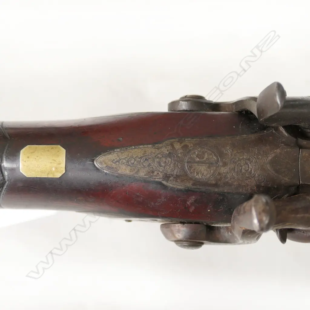 12g Double Barrel Percussion Shotgun by Alex Thompson, Edinburgh. 30" barrels. Metal with good Damascus pattern. Action strong, LH hammer a replacement. Lock with light engraving, steel butt plate and trigger guard with engraving. Wood in good tidy condition with chequering to wrist. Provenance: NZAHAA, 12/07/2014, Lot 1073, $760. *NO LICENCE REQUIRED Image 1++