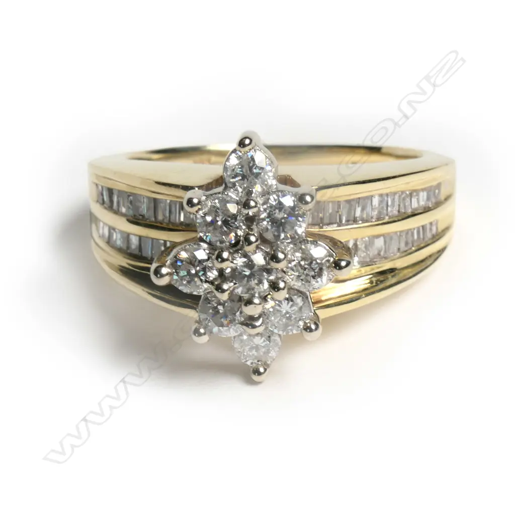 A 10ct gold diamond cluster ring the marquis form mount set with nine brilliant cut diamonds, together with forty taper cut diamonds channel set in two rows to each shoulder. TDW. 1.14ct. Valuation available.         SIZE L 1/2 Image 1++