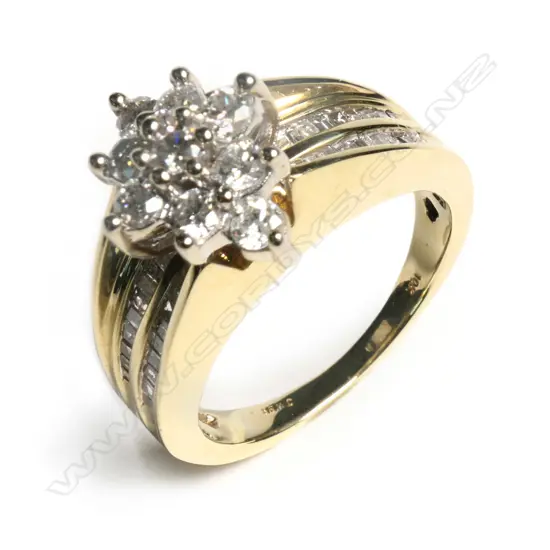 A 10ct gold diamond cluster ring the marquis form mount set with nine brilliant cut diamonds, together with forty taper cut diamonds channel set in two rows to each shoulder. TDW. 1.14ct. Valuation available.         SIZE L 1/2