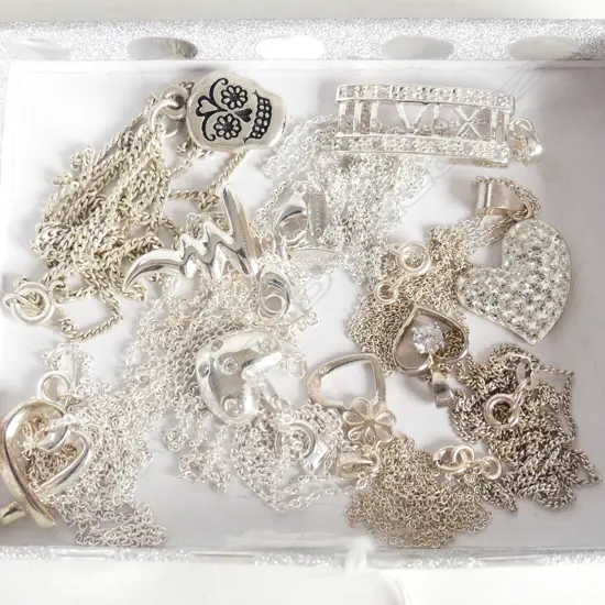 EIGHT ASSORTED SILVER PENDANTS &  CHAINS