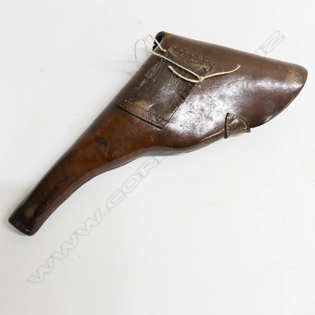 Brown leather-flap type holster with brass stud dome and leather strap, Image 1++