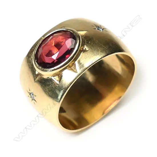 A heavy 18ct yellow gold garnet and diamond wide ring,