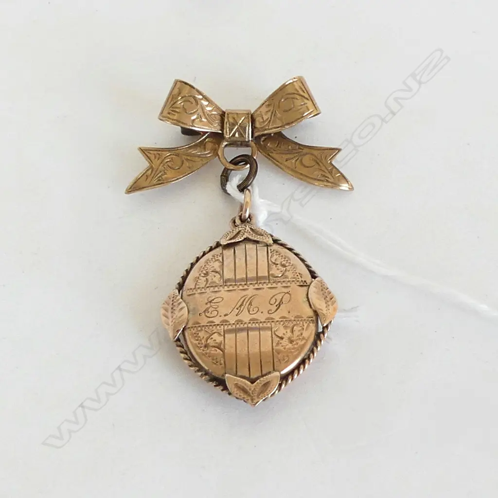 9CT BOW & LOCKET 7.2gms Image 1++