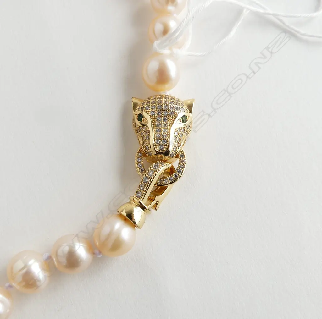 STRAND LARGE FRESH WATER CULTURED PEARL NECKLACE with gilt leopard head clasp set w white & green stones. L.400mm Image 1++