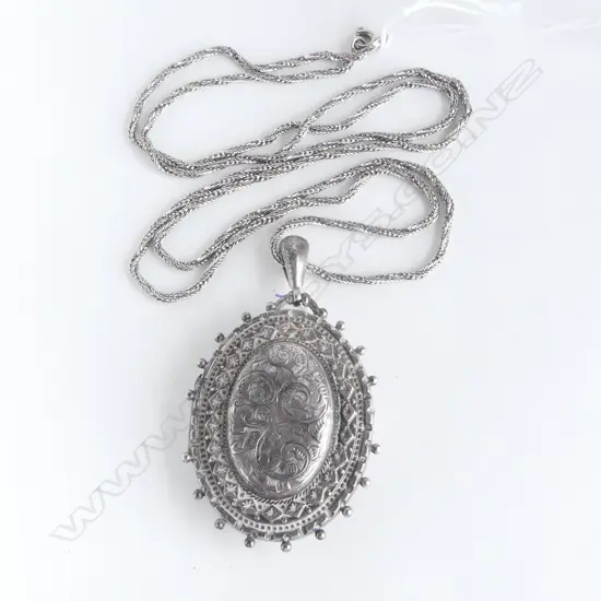 EDWARDIAN SILVER LGE FANCY LOCKET on later chain (dents to locket)