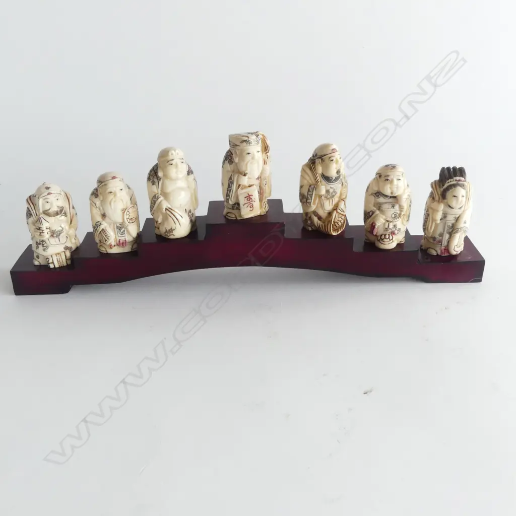 COLLECTION OF 7 BONE NETSUKE ON STAND L260MM Image 1++