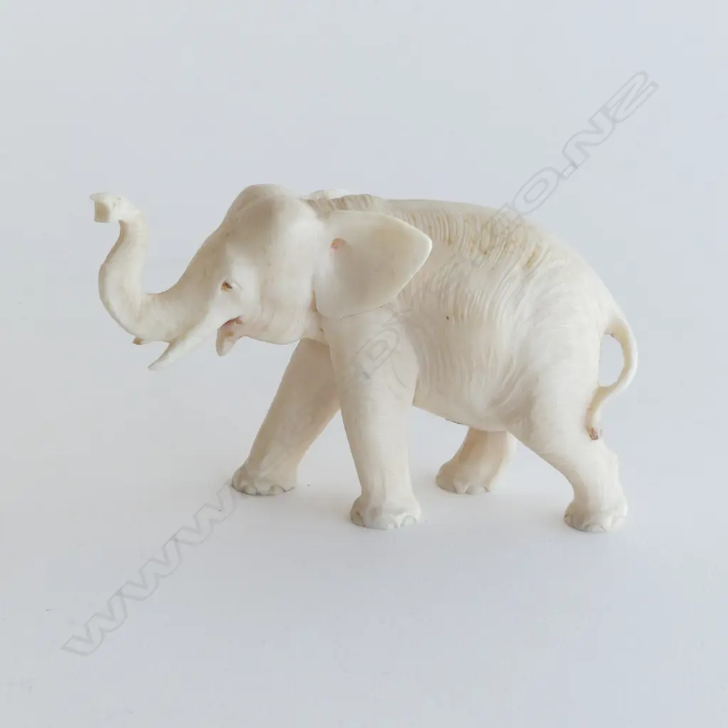 IVORY CARVED ELEPHANT trunk raised. L.85mm. Image 1++