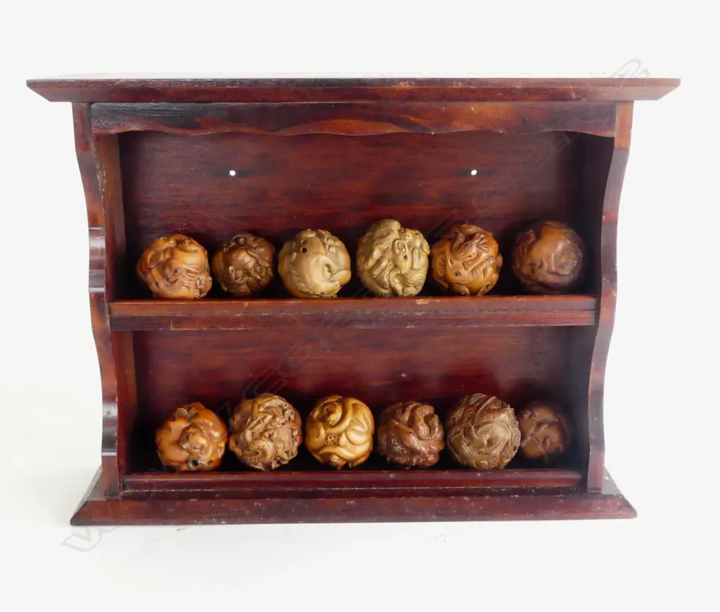 COLLECTION OF 12 ROUND CARVED WOOD NETSUKE  IN WOODEN WALL RACK  Image 1++