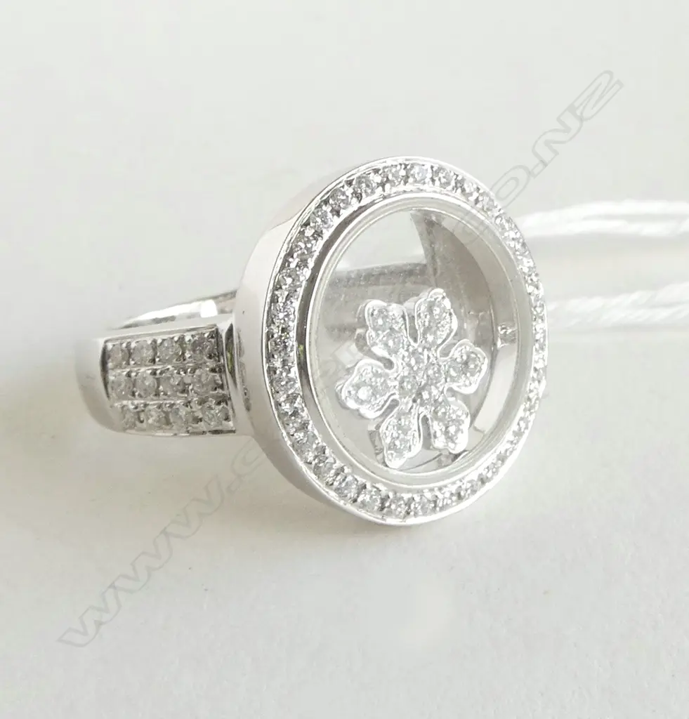 18CT WHITE GOLD & DIAMOND RING 83 diamonds TDW. 0.47ct. Retail $7200. floating center diamond cluster enclosed in glass Image 1++