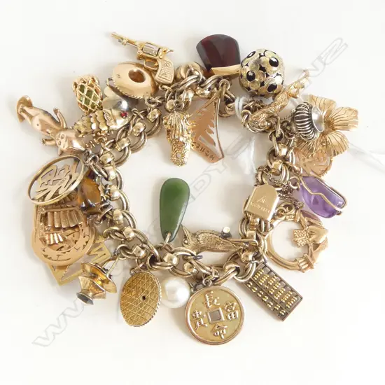 MULTIPLE GOLD CHARMS (9+10+14ct gold) on GOLD PLATE BRACELET. 61.6gms total