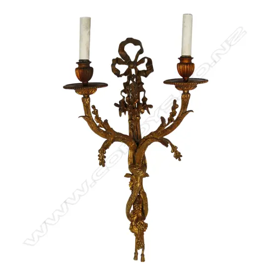 An early 20thC French gilded bronze wall sconce in the form of budding branches held together by a bow, two light branches. Requires rewiring. 330 x 570mm.