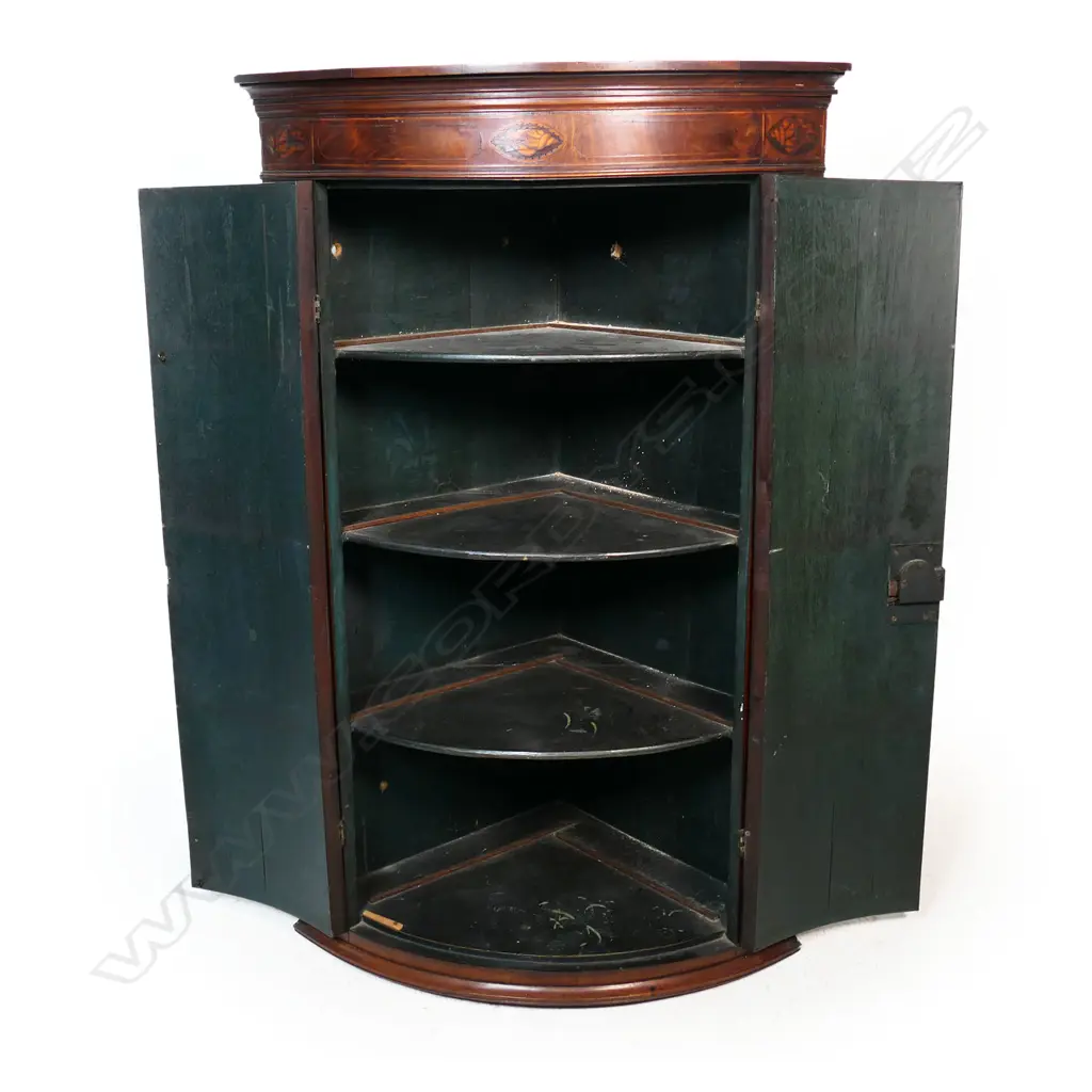 A Georgian mahogany Sheraton style corner cabinet, inlaid stringing, the pediment with shell detail, three shelves to the painted interior. 800 x 460 x 1100mm. Image 1++