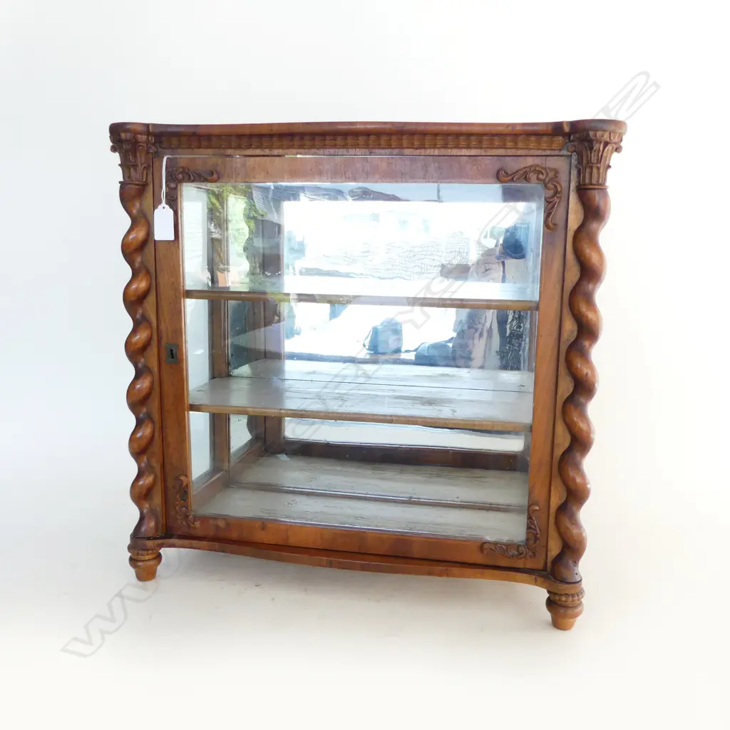 A small walnut display cabinet barley twist columns to the side with applied decoration to glazed door the interior with two painted shelves and mirror back. (some decoration absent). 500 x 225 x 485mm. Image 1++